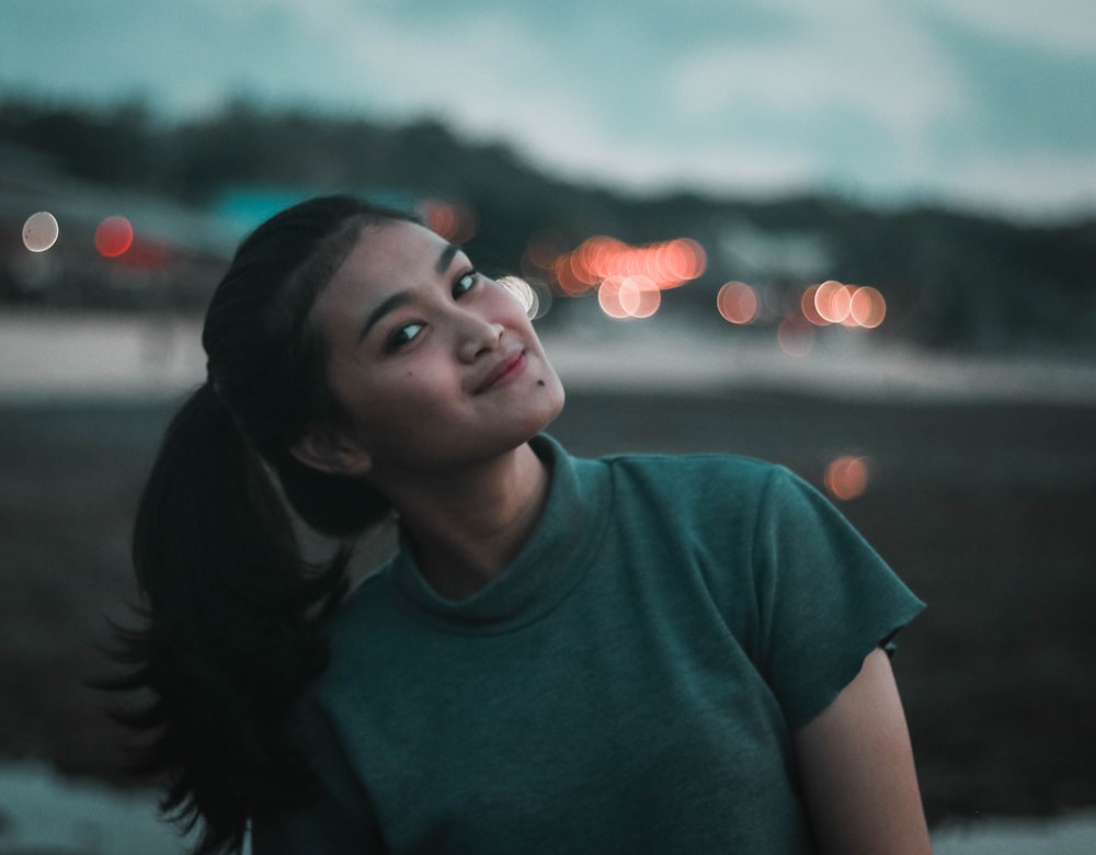 bokeh photography of woman with pony-tailed hair