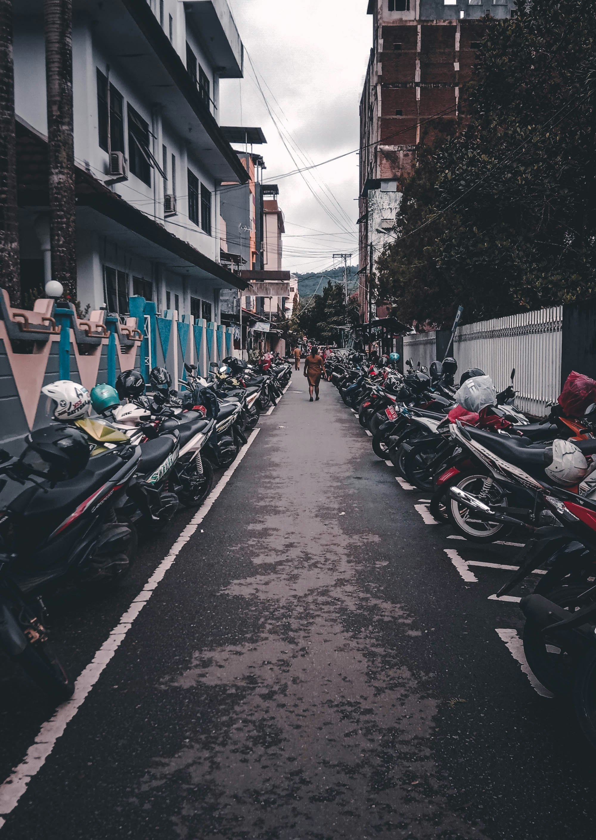 motorcycles parked in both sides of alley