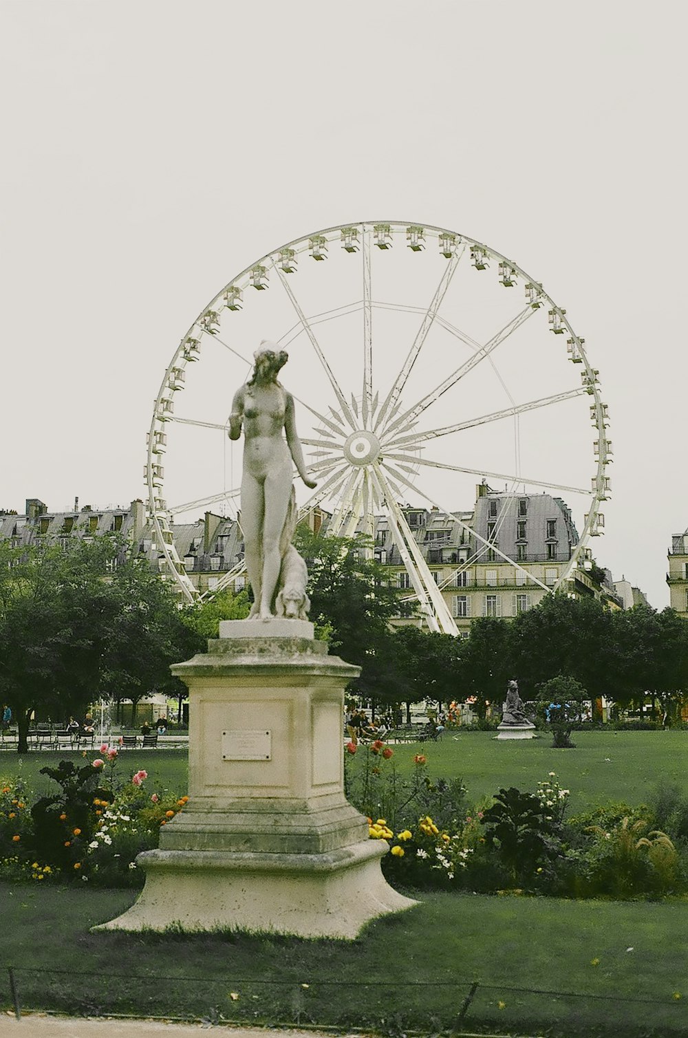 gray concrete woman standing statue during daytime