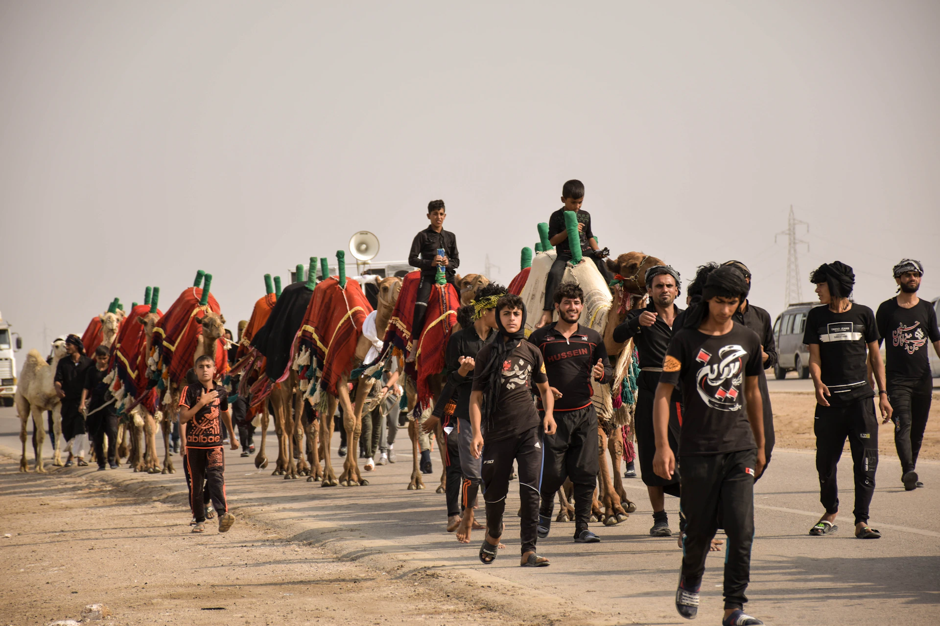 a group of people riding on the backs of camels