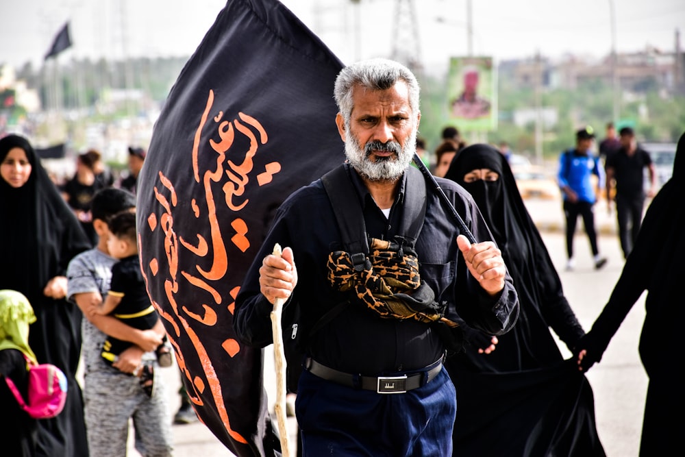 man holding black flag