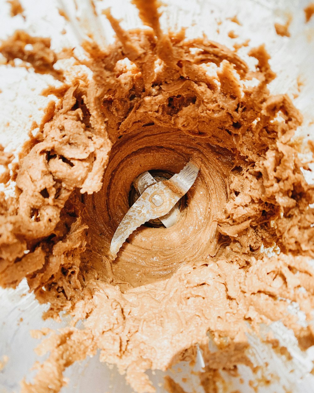 a bowl filled with a mixture of brown batter