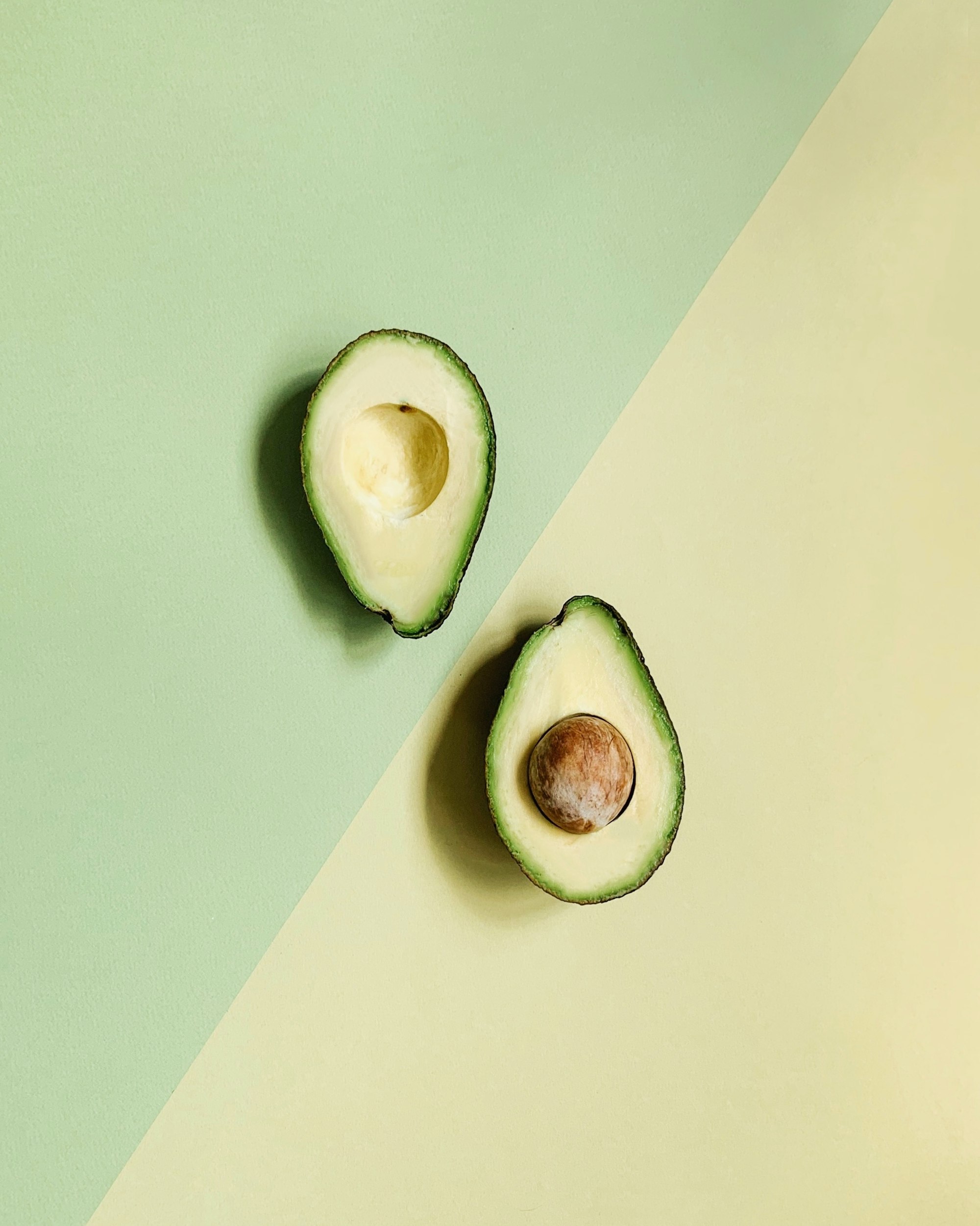 Two halves of an avocado. In this post we also explain how to soften an avocado