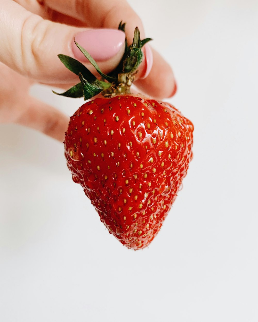 person holding strawberry