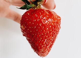 person holding strawberry