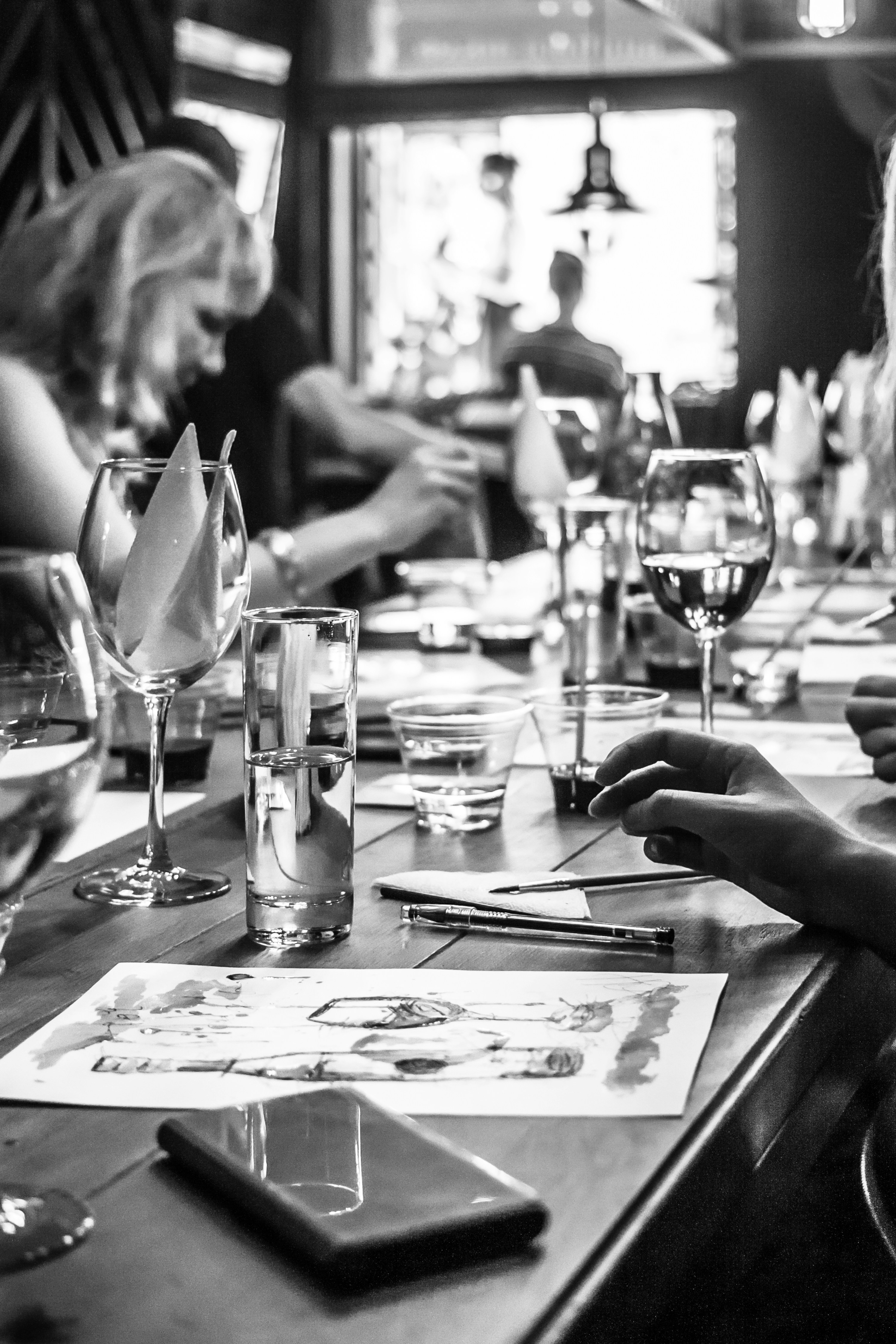 grayscale photo of people in bar
