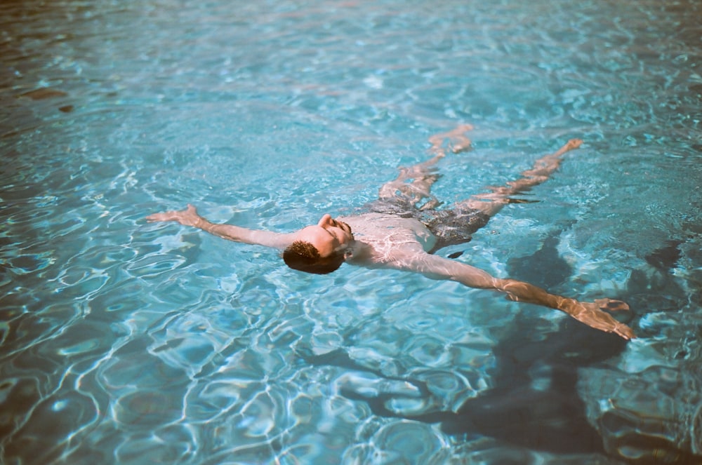 man floating on pool