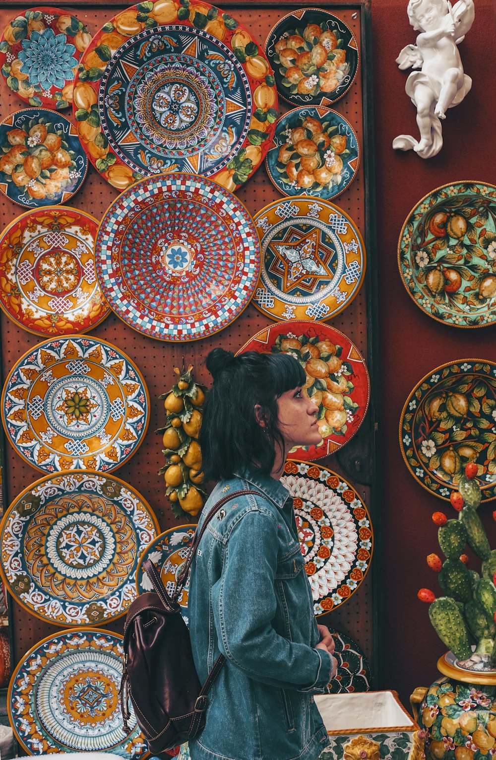 woman wearing blue denim jacket across plates