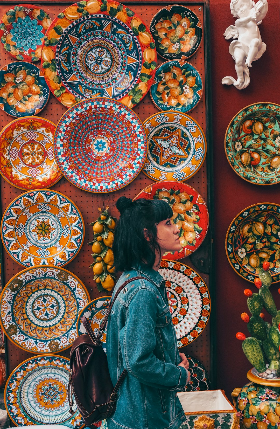 woman wearing blue denim jacket across plates