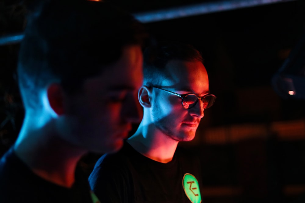 two men wearing black crew-neck shirt