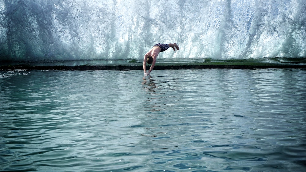 man jumping into pool