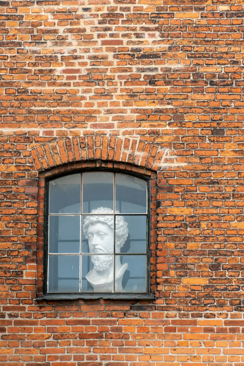 man headbust in closed window