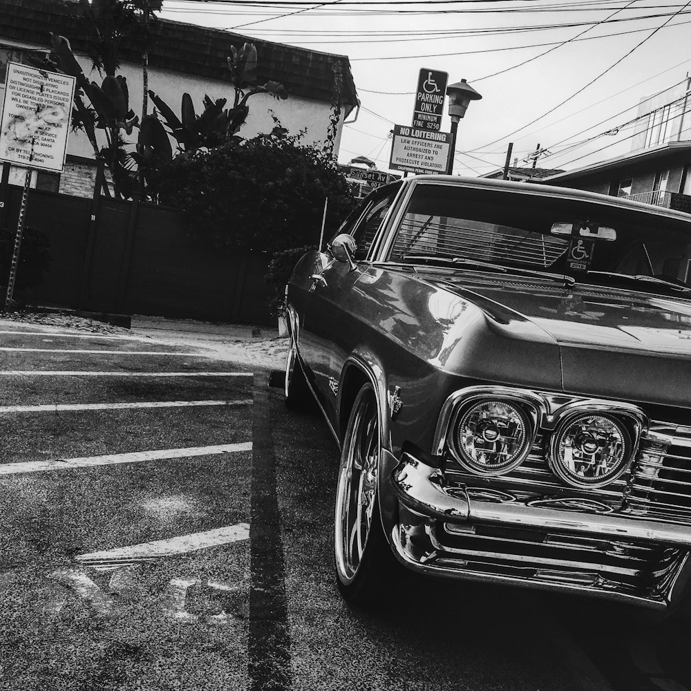 grayscale photography of car on parking area