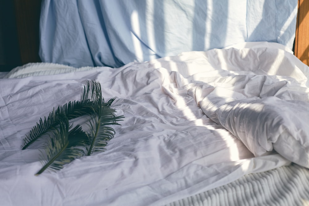 green leaves on white bedspread