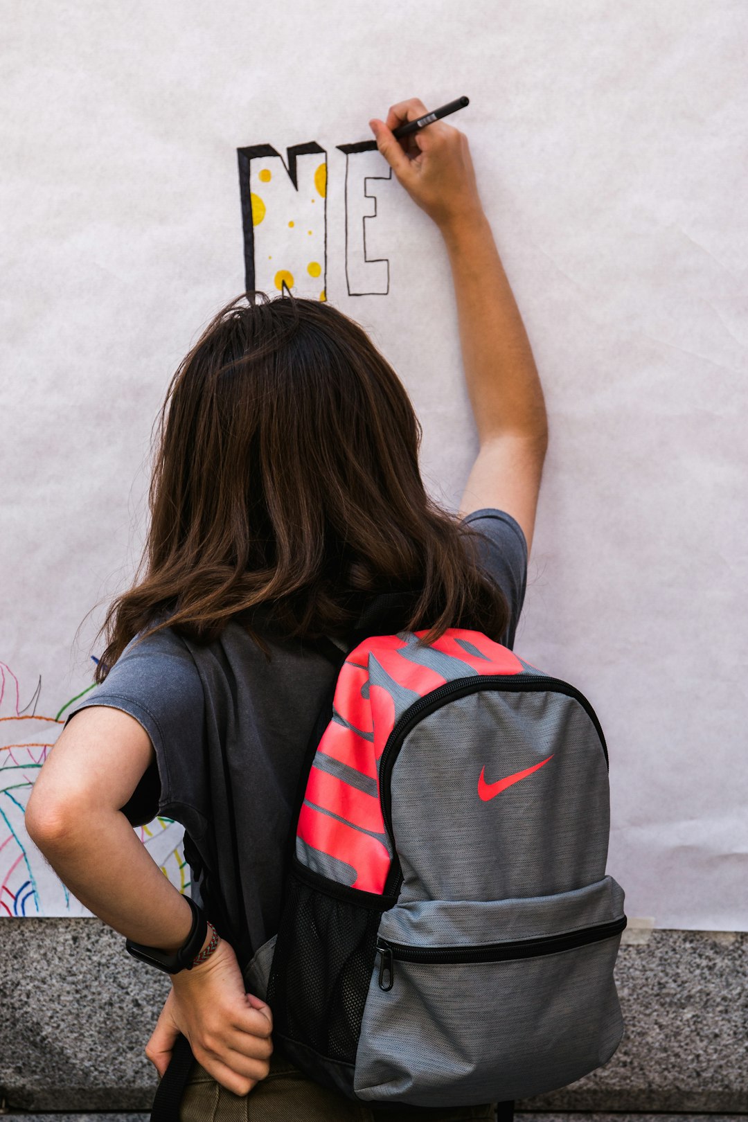 girl writing on wall