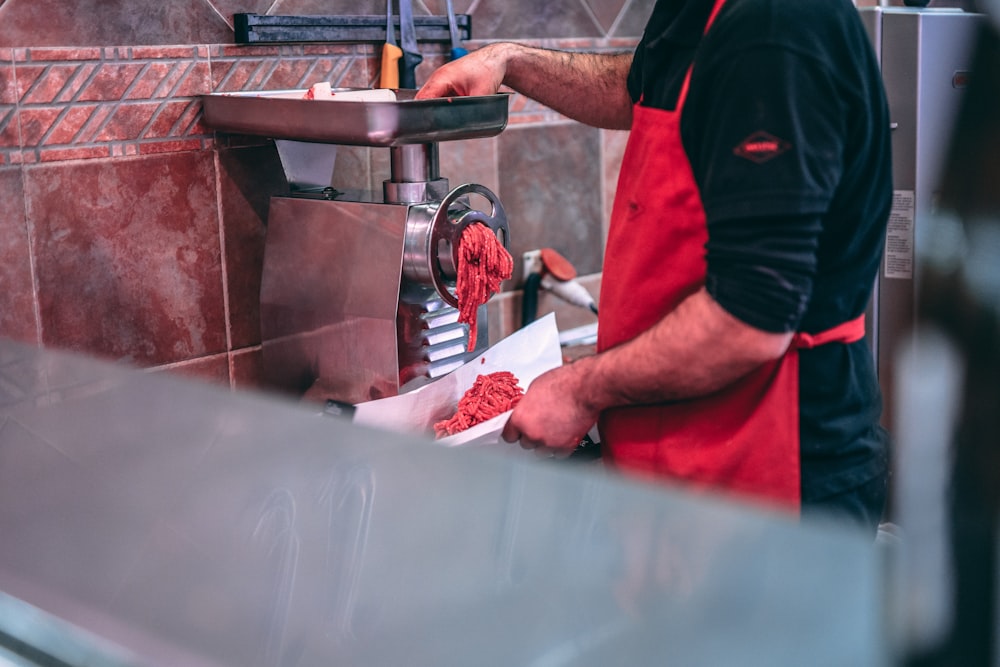 man grinding meat