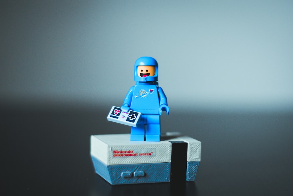 selective focus photography of blue LEGO minifigure