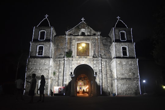 grey concretet church during nighttime in Bacnotan Philippines