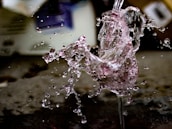 A close-up shot from a creative video featuring colorful paint splashes in slow motion.