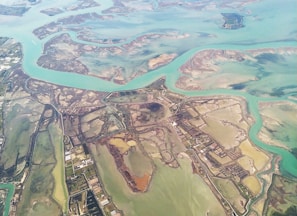 aerial photography of houses viewing field and sea