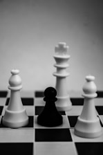 grayscale photo of king, pawn, and bishop chess pieces