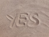 yes text on brown sand