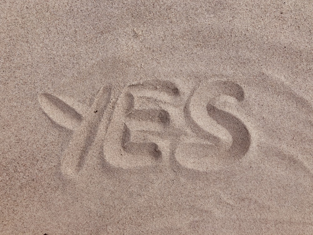 yes text on brown sand