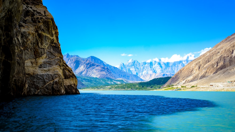 calm body of water overlooking mountain range