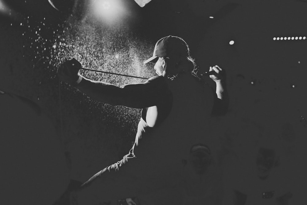grayscale photography of man performing on stage