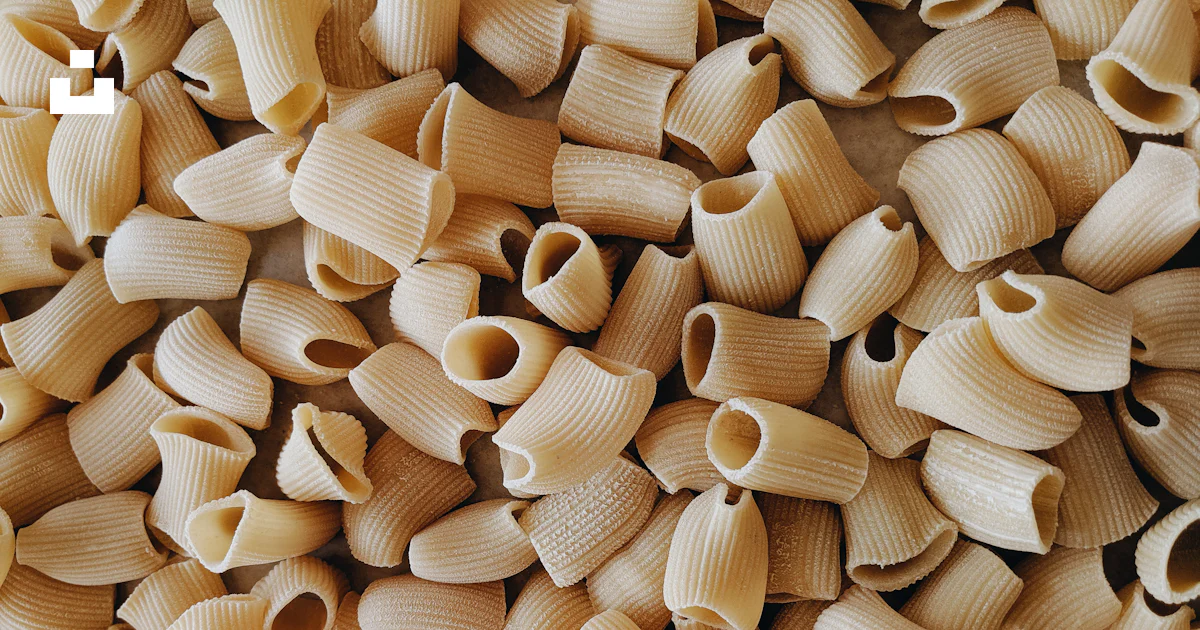 A pile of uncooked macaroni shells on a table photo – Free Brooklyn ...
