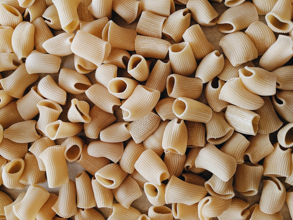 a pile of uncooked macaroni shells on a table