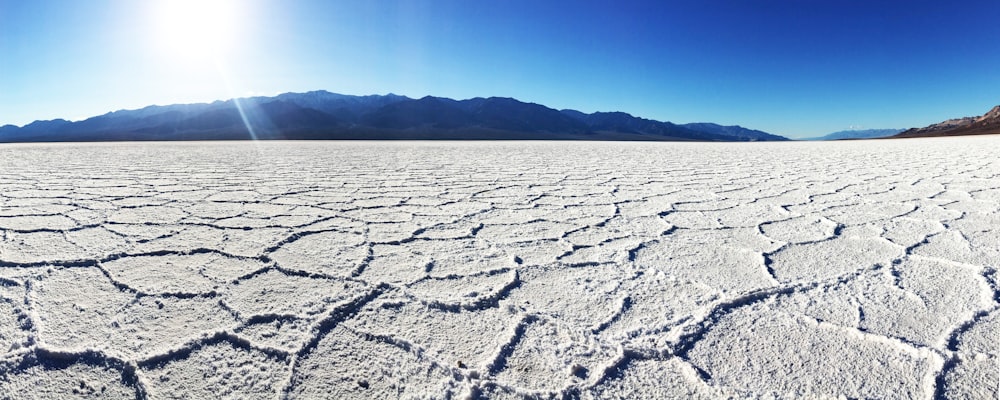 the sun shines brightly over a barren landscape