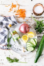 onion lemon and gourd on white plate