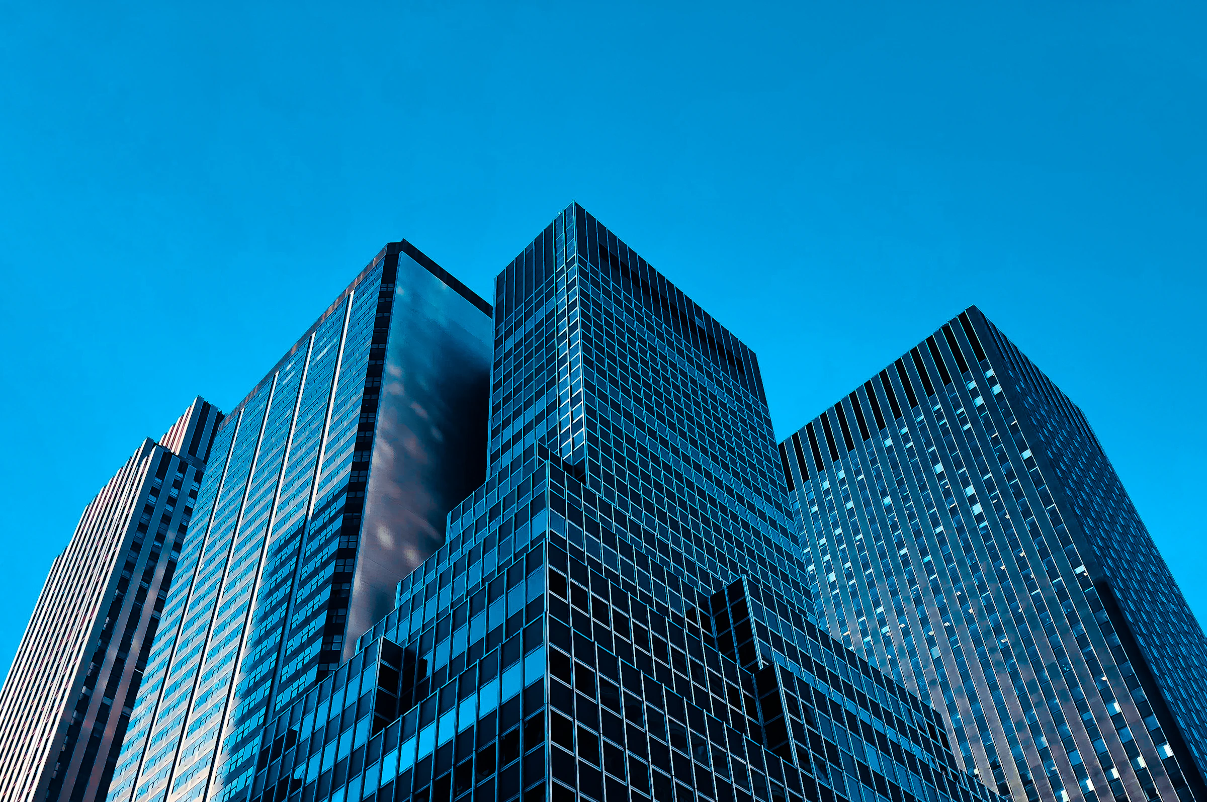 Modern glass corporate headquarters at dusk