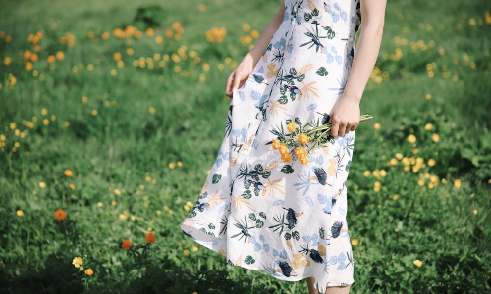 woman standing and holding flowers