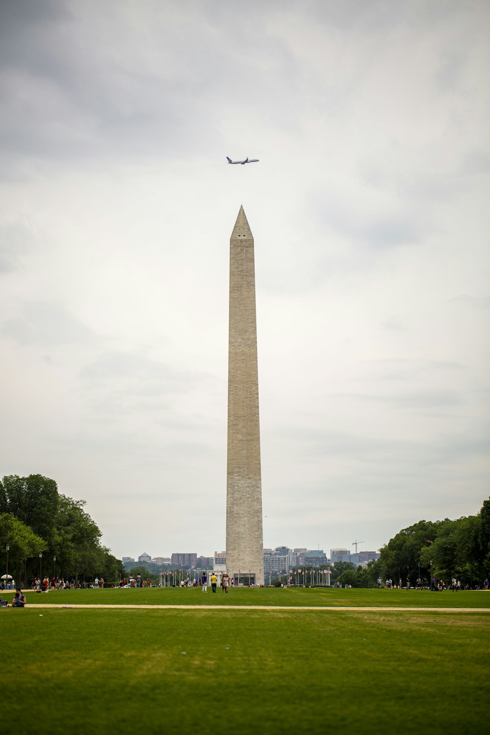 airplane over obelisk monument