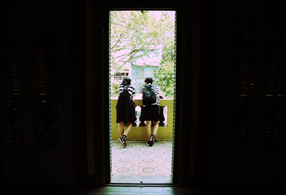 two women leaning on handrail