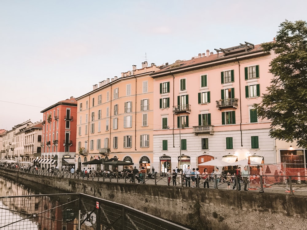 people near parasols and buildings