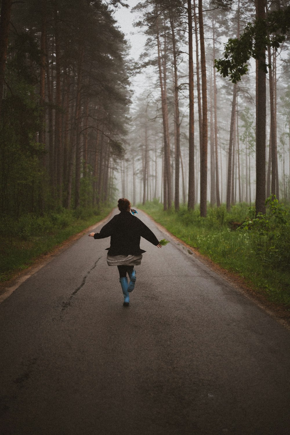 person walking on road about to raise hands