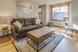 Comfortable gray fabric sofa with colorful cushions in a cozy living room.