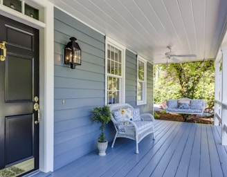 a porch with two chairs and a table on it at the front of your home, cheap home insurance Toledo