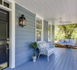 a porch with two chairs and a table on it