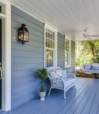 a porch with two chairs and a table on it