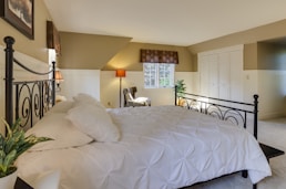 white mattress sheet and four white pillows