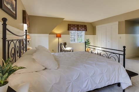 white mattress sheet and four white pillows