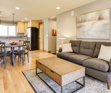 rectangular brown wooden coffee table and gray 3-seat sofa