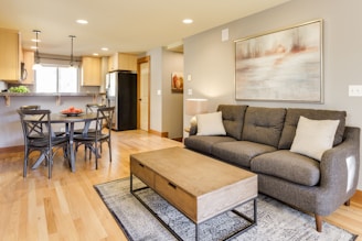 rectangular brown wooden coffee table and gray 3-seat sofa