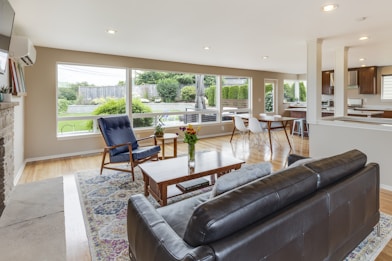 brown leather couch in front of brown wooden coffee table