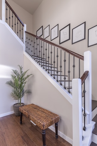 brown wooden bench near white stair