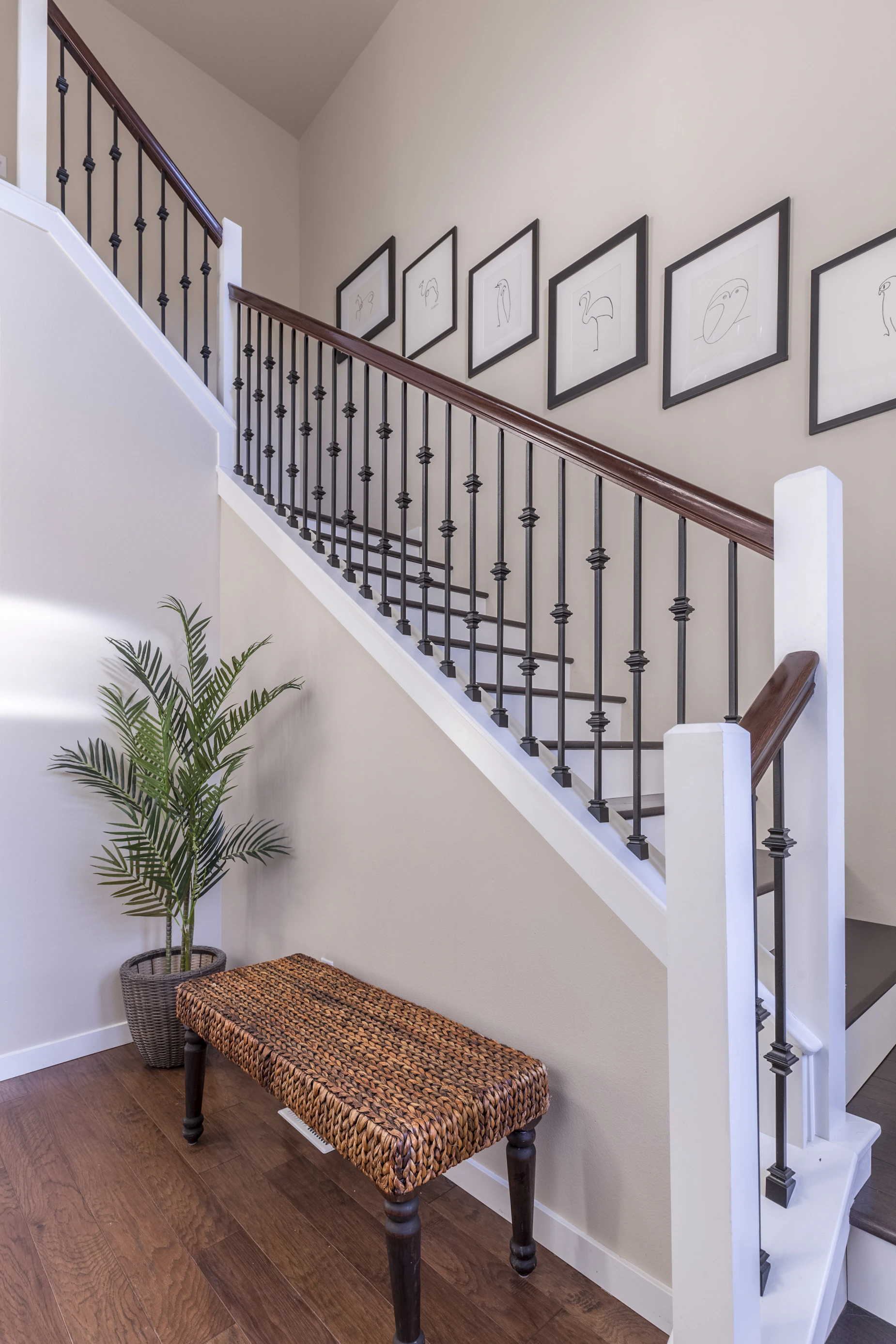 Residential interior with a wooden bench beside a staircase
